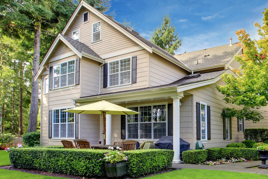 Large beige house with green grass
